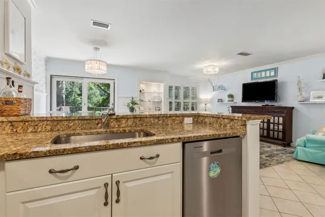 a kitchen with granite countertop a sink and a stove top oven