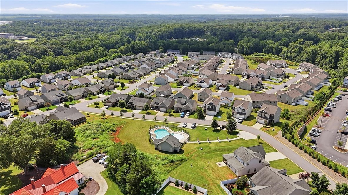 208 Grassy Creek Way Pendleton, SC 29670 - Photo 38 of 43 An aerial perspective reveals a vibrant neighborhood with ample green spaces and a refreshing community pool.