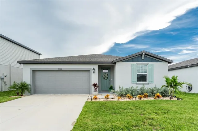a front view of house with a garden