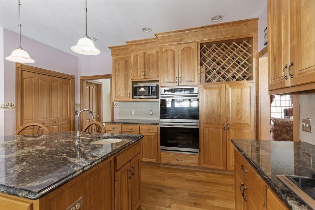 171 Scantic Road Hampden, MA 01036 - Photo 13 of 42 a kitchen with stainless steel appliances granite countertop a sink a stove and a refrigerator