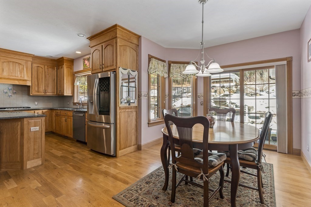 171 Scantic Road Hampden, MA 01036 - Photo 14 of 42 a dining room with stainless steel appliances granite countertop a dining table chairs refrigerator and kitchen view