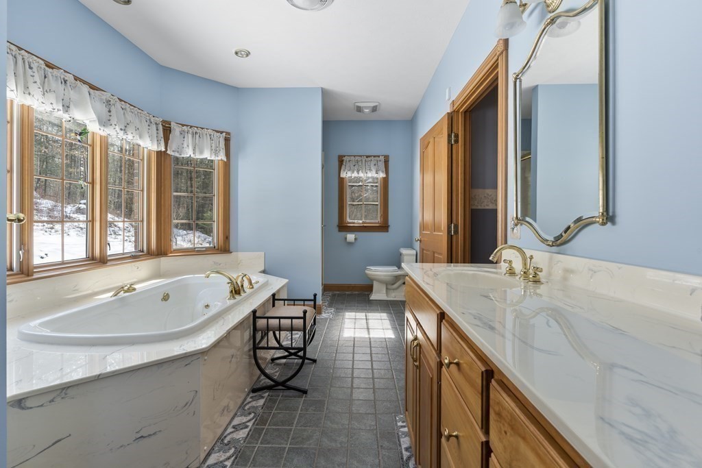171 Scantic Road Hampden, MA 01036 - Photo 18 of 42 a spacious bathroom with sinks mirror and a bathtub