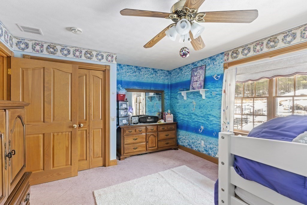 171 Scantic Road Hampden, MA 01036 - Photo 22 of 42 a spacious bedroom with a bed and a chandelier