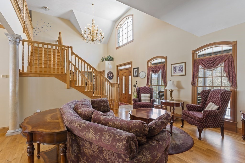 171 Scantic Road Hampden, MA 01036 - Photo 4 of 42 a living room with furniture a chandelier and a flat screen tv