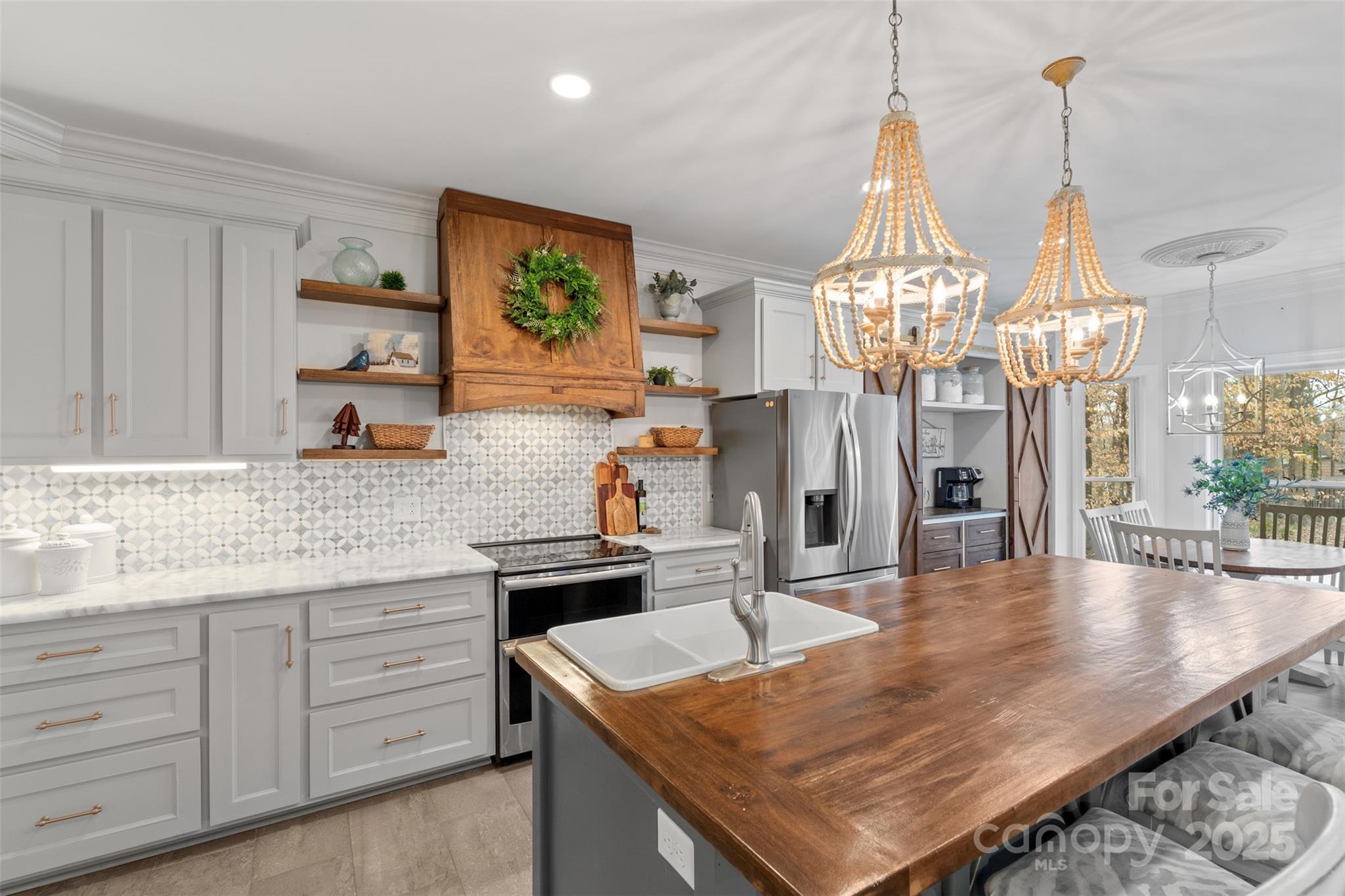 1135 Ben Black Road Midland, NC 28107 - Photo 6 of 38 a kitchen with stainless steel appliances granite countertop a sink dishwasher cabinets a dining table and chairs with wooden floor