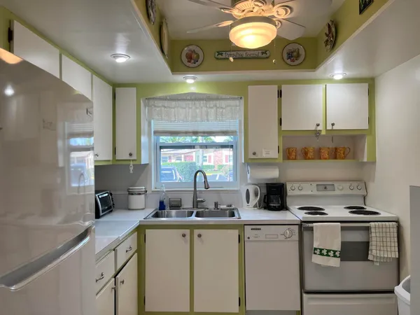 a kitchen with a stove cabinets and a window