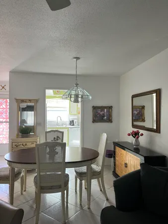 a view of a dining room with furniture and window