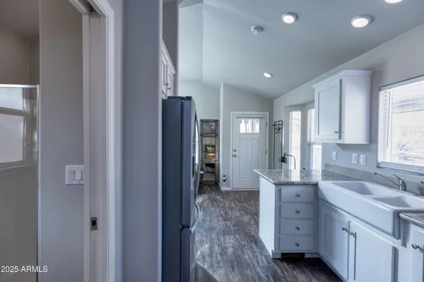 a spacious bathroom with a double vanity sink a mirror and a shower