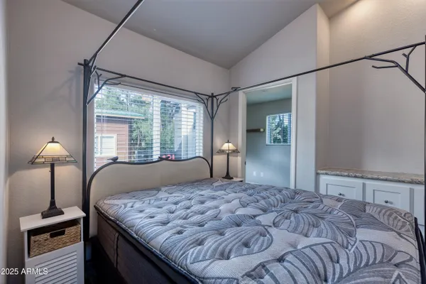a bedroom with a large bed and a window