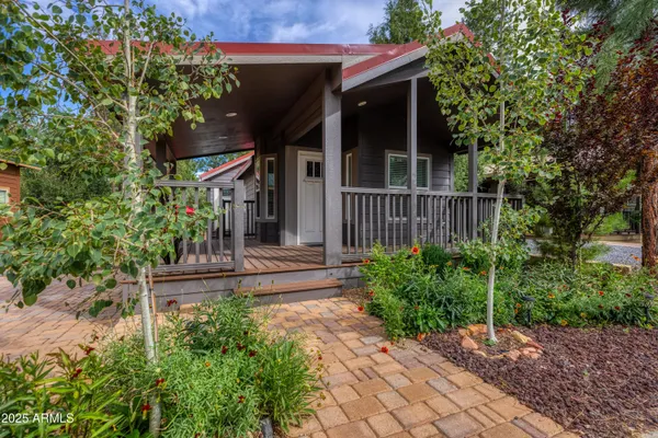 a view of a house with a small yard and plants