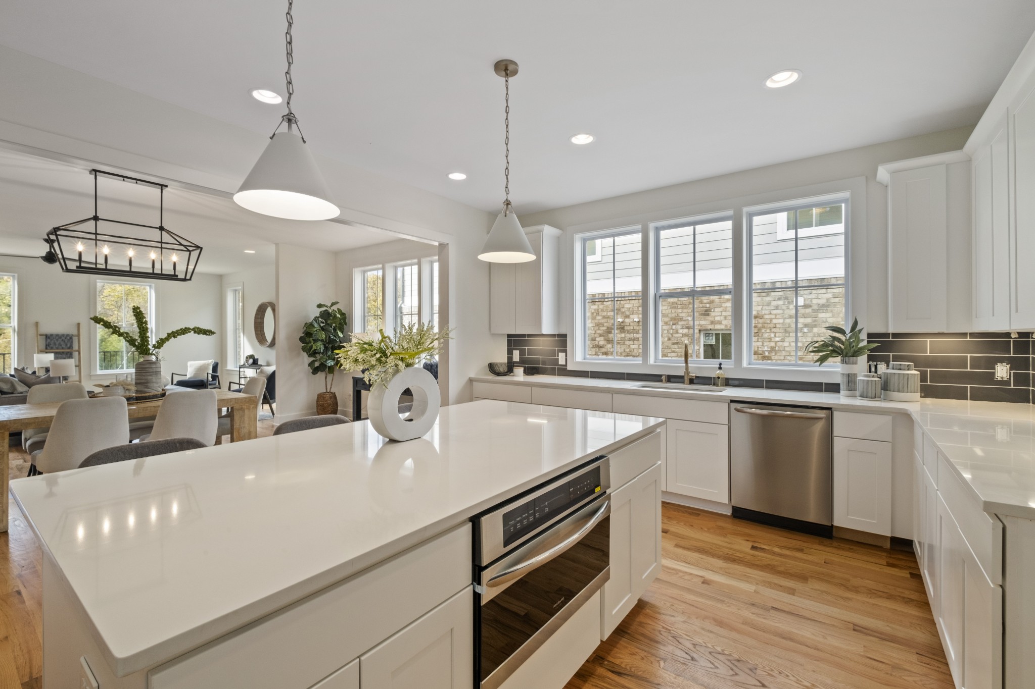 111 Demoss Road Nashville, TN 37209 - Photo 20 of 38 a kitchen with kitchen island granite countertop a stove a sink a center island and windows