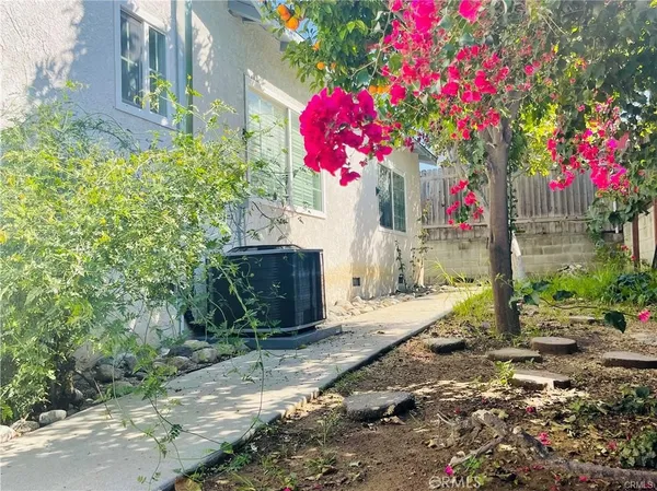 a front view of a house with flower garden