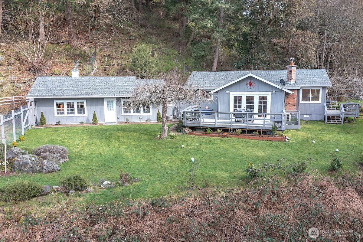 a front view of a house with a yard table and chairs