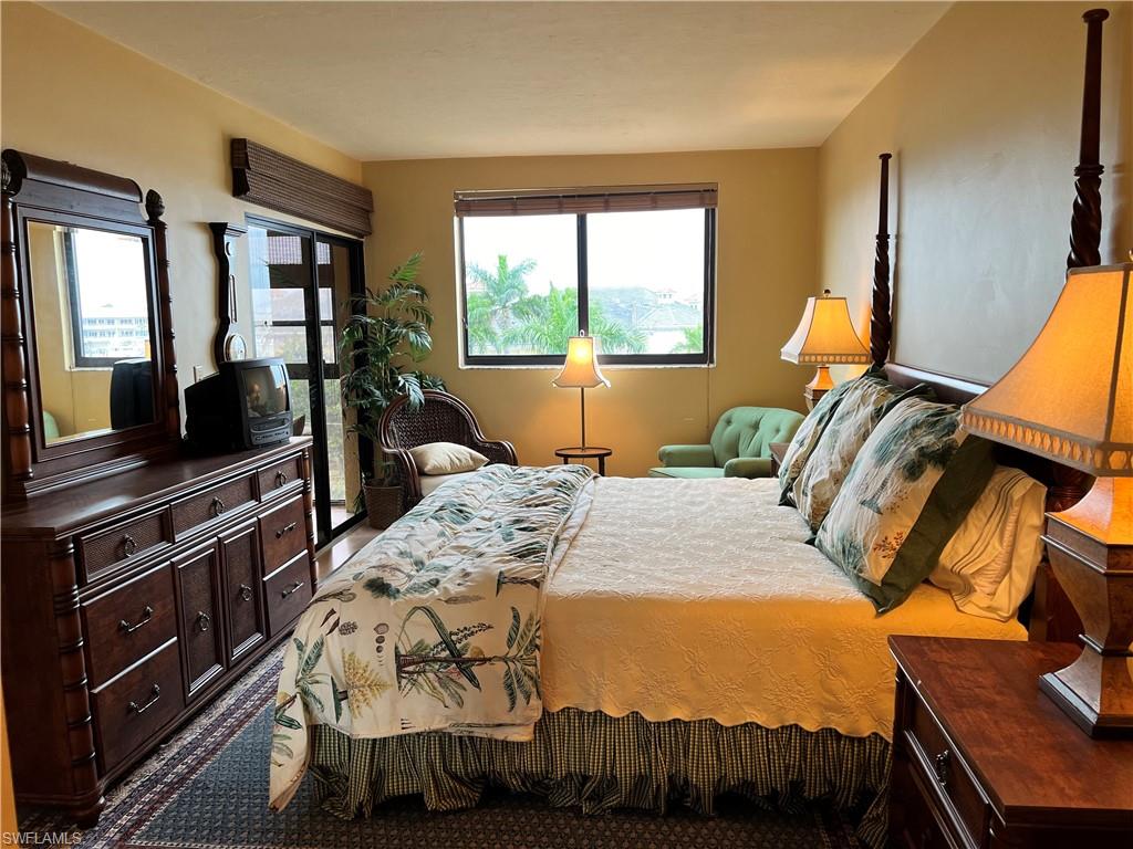 807 River Point Drive, Unit 304D Naples, FL 34102 - Photo 11 of 23 a bed sitting in a bedroom next to a window