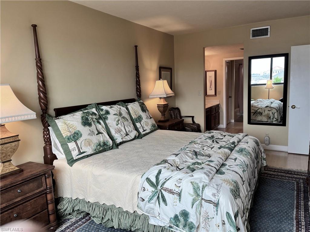807 River Point Drive, Unit 304D Naples, FL 34102 - Photo 12 of 23 a bedroom with a large bed and a window