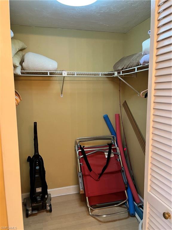 807 River Point Drive, Unit 304D Naples, FL 34102 - Photo 14 of 23 a view of walk in closet with clothes and shoes