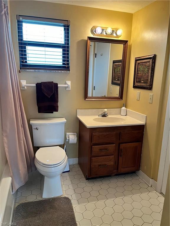 807 River Point Drive, Unit 304D Naples, FL 34102 - Photo 16 of 23 a bathroom with a toilet sink and mirror
