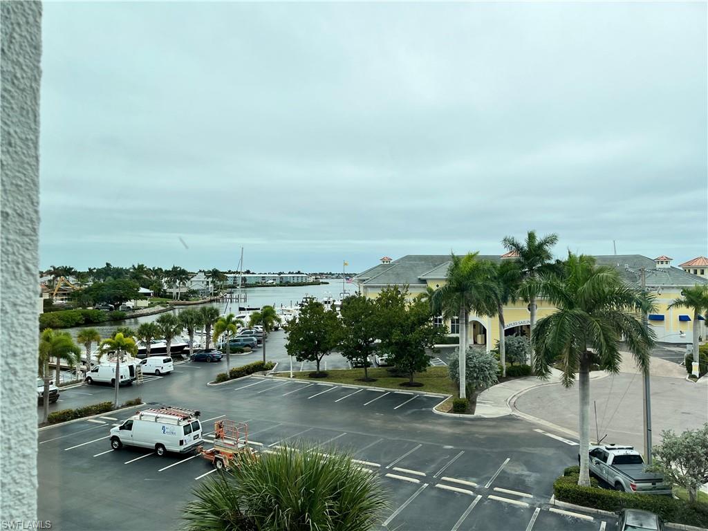 807 River Point Drive, Unit 304D Naples, FL 34102 - Photo 18 of 23 a view of a parking space with lots of palm trees