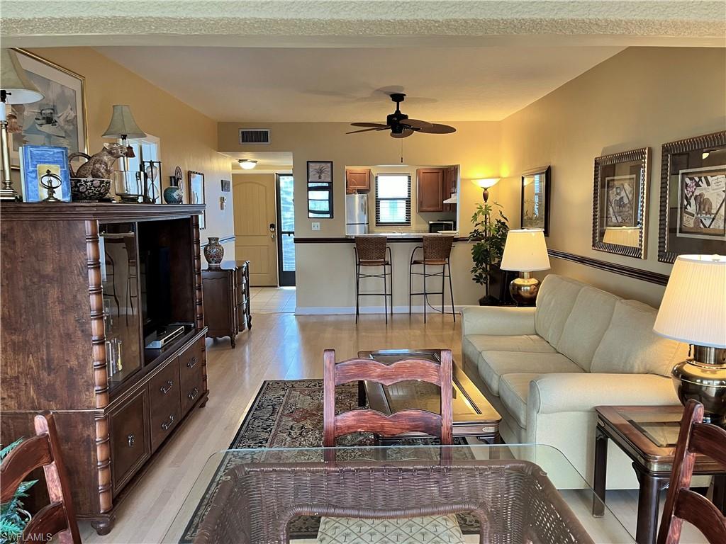 807 River Point Drive, Unit 304D Naples, FL 34102 - Photo 6 of 23 a living room with furniture and a flat screen tv