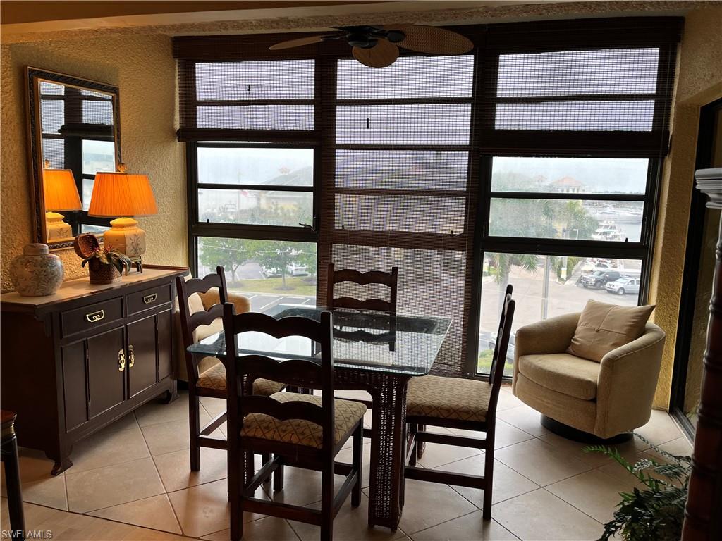 807 River Point Drive, Unit 304D Naples, FL 34102 - Photo 8 of 23 a dining room with furniture and a window