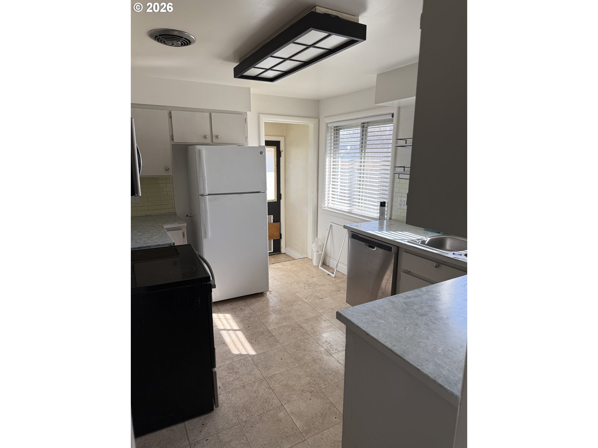 225 Southwest 7th Place Hermiston, OR 97838 - Photo 11 of 13 a kitchen with a refrigerator and a cabinets