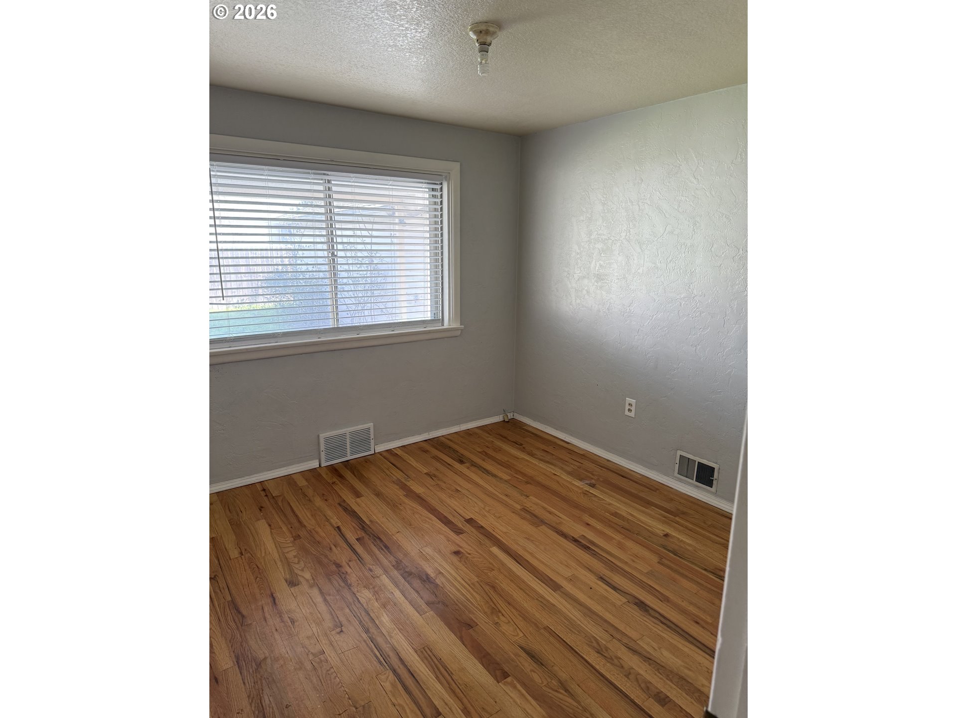 225 Southwest 7th Place Hermiston, OR 97838 - Photo 10 of 13 a view of a room with wooden floor and a window