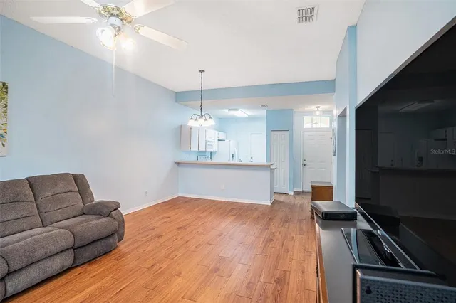 a living room with furniture and a chandelier