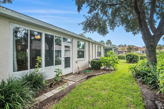 an aerial view of a house with garden space and lake view