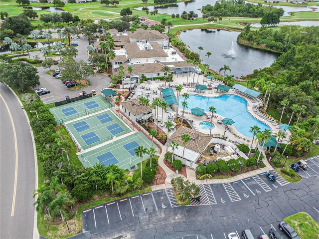 an aerial view of a house with a garden and lake view