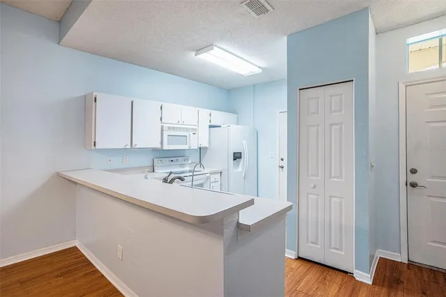 a view of a kitchen with wooden floor
