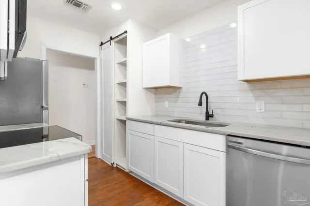 a kitchen with sink cabinets and a refrigerator