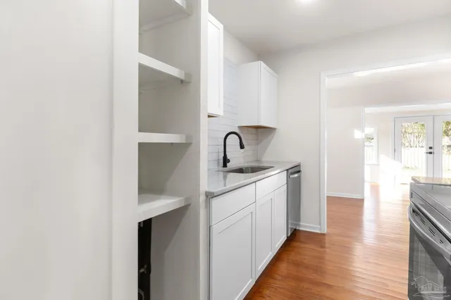 a kitchen with sink and cabinets