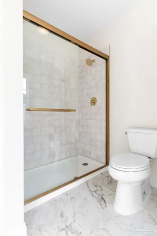 a bathroom with a shower and a toilet