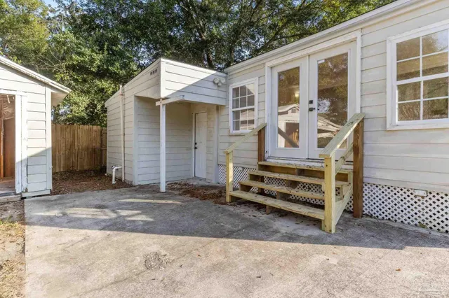 a view of wooden house with a yard