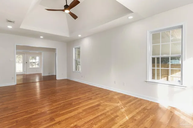 wooden floor in an empty room with a window