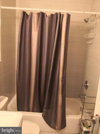 a bathroom with a shower and a toilet