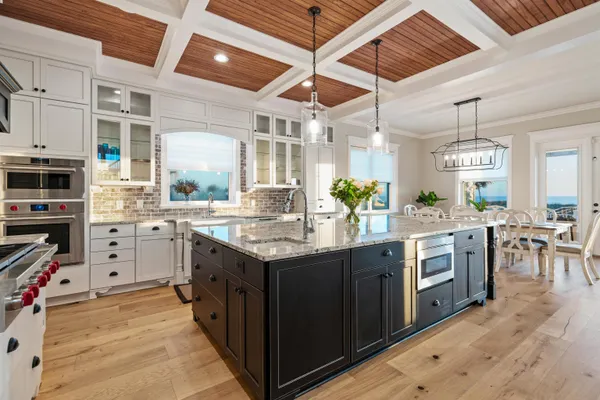 a view of a hallway with wooden floor and glass door