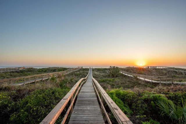 a bedroom with a large bed and a flat tv screen on a dresser