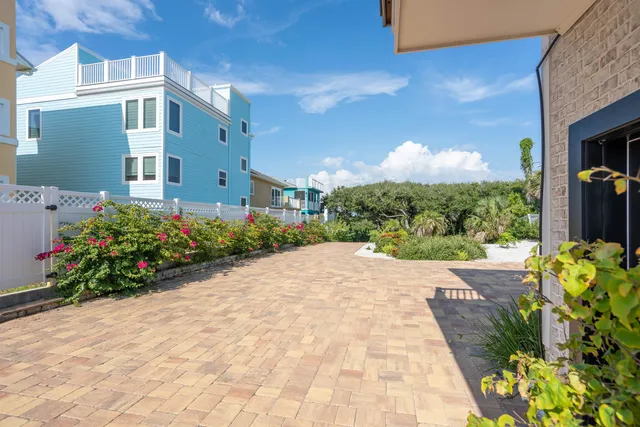a view of a dining room with furniture large windows and wooden floor