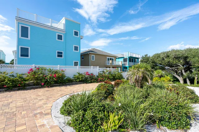 a kitchen with stainless steel appliances kitchen island granite countertop a table chairs in it and wooden floors