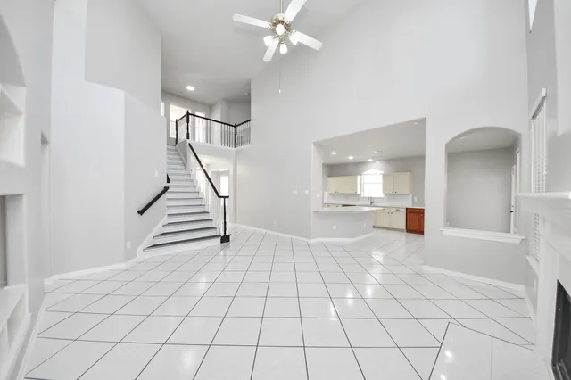 a view of an empty room and staircase