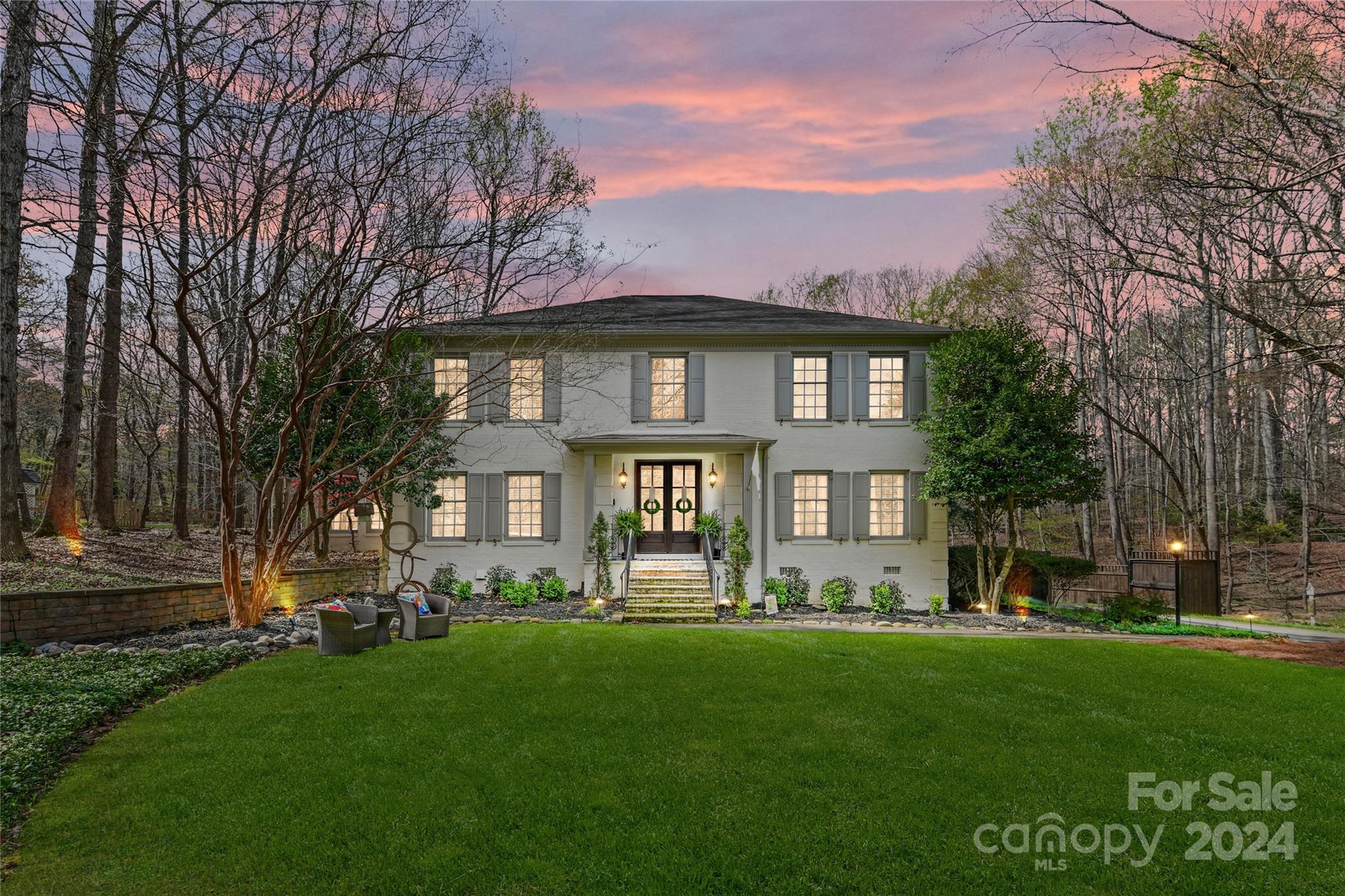 a front view of a house with a garden