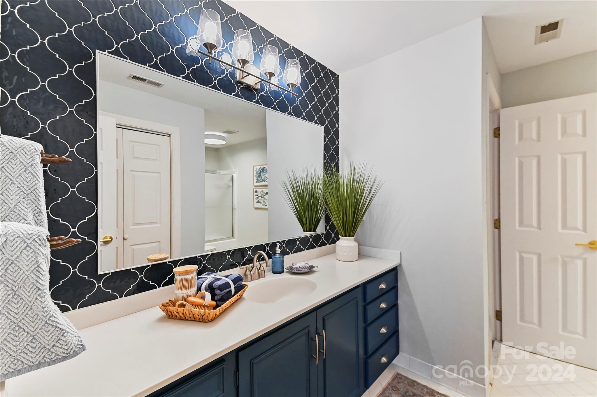 3023 High Ridge Road Charlotte, NC 28270 - Photo 32 of 48 a bathroom with a sink and a mirror