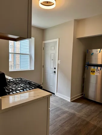 a view of a kitchen with a sink and a stove top oven