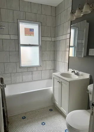 a bathroom with a sink a toilet and bathtub