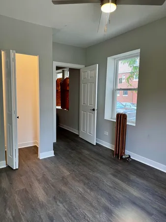 an empty room with wooden floor and closet