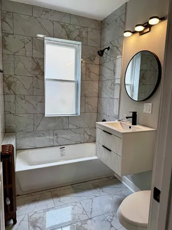 a bathroom with a sink a toilet and a bathtub