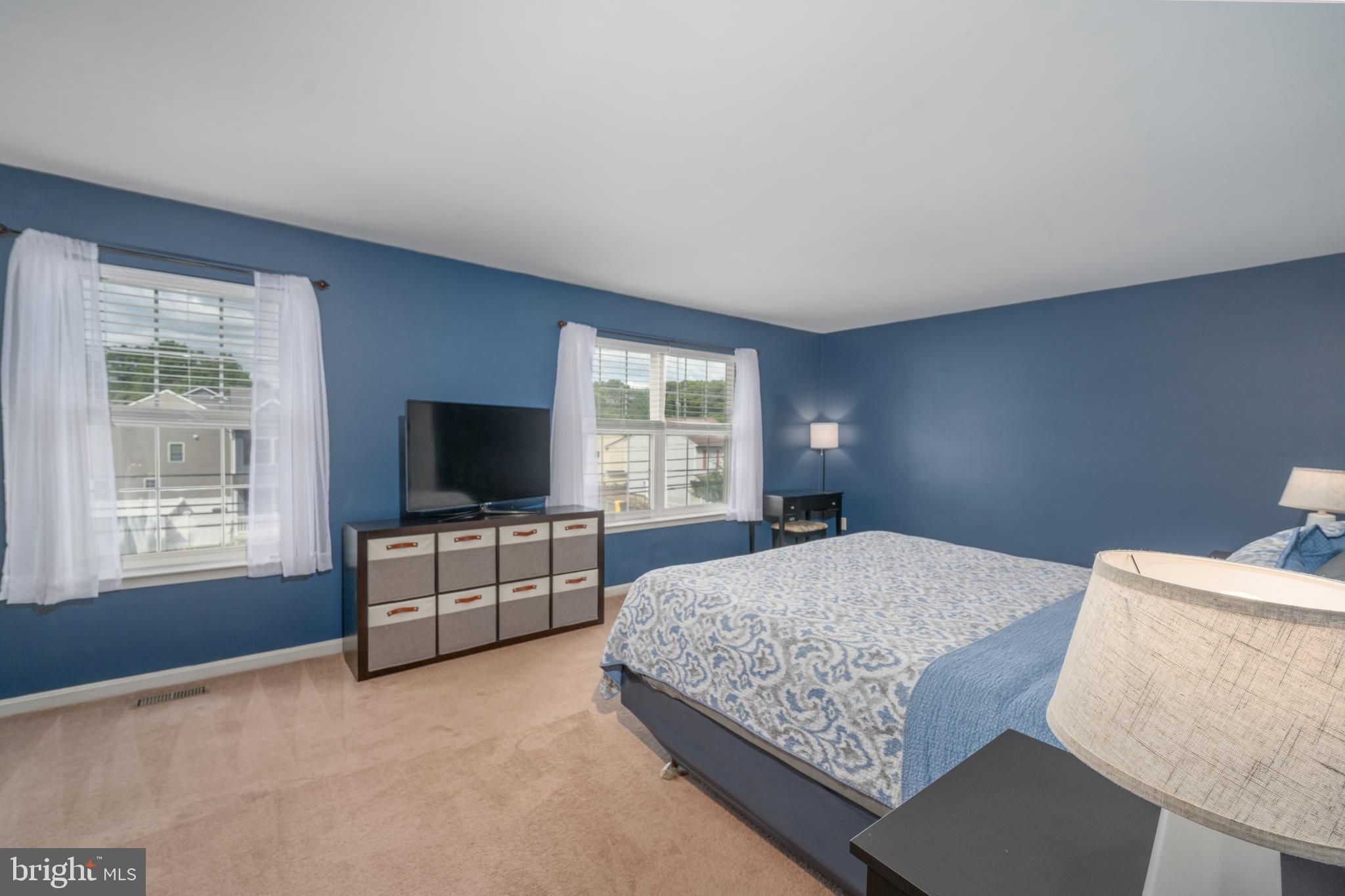 7815 Outing Avenue Pasadena, MD 21122 - Photo 14 of 37 a bedroom with a bed and a flat screen television