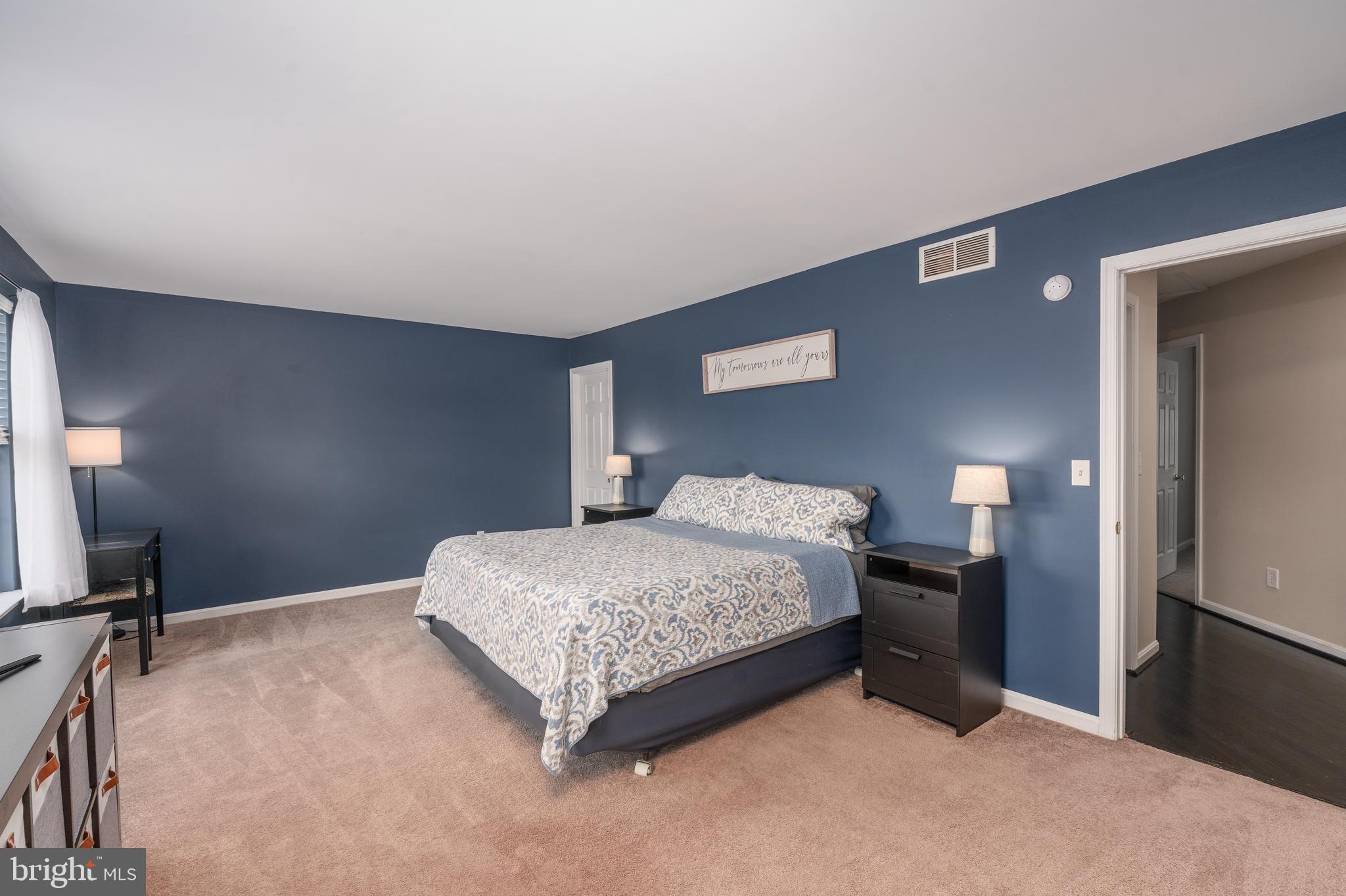 7815 Outing Avenue Pasadena, MD 21122 - Photo 15 of 37 a bedroom with a bed and a tv on table