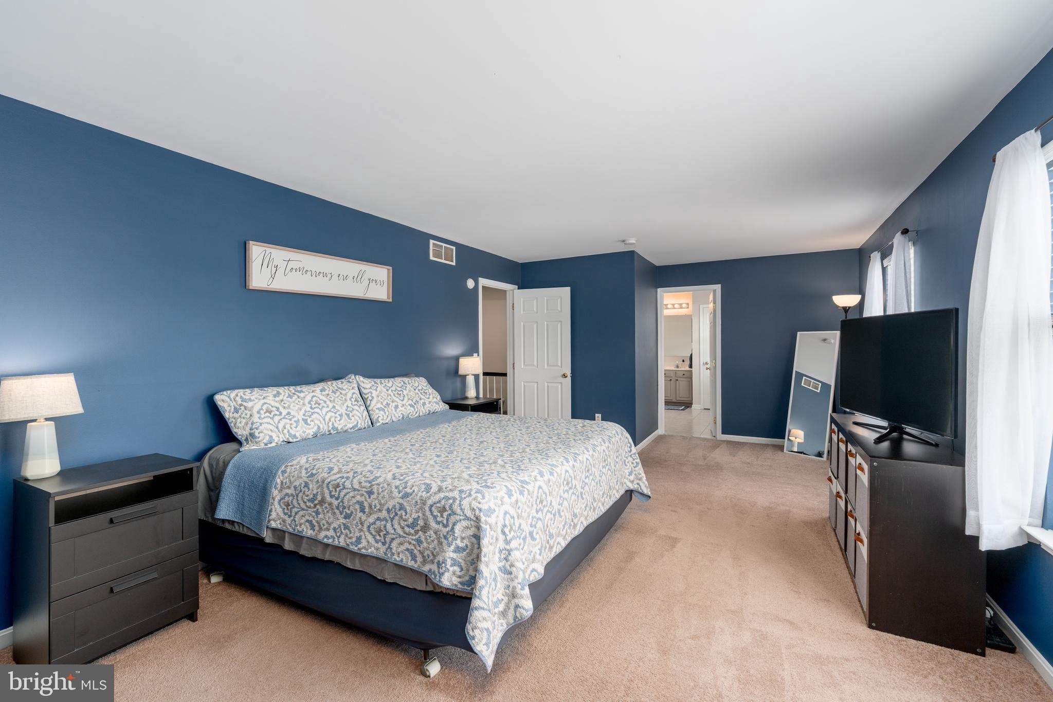 7815 Outing Avenue Pasadena, MD 21122 - Photo 16 of 37 a bedroom with a bed and a flat screen tv